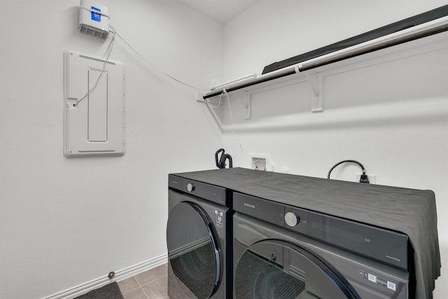 washroom featuring washing machine and clothes dryer and light tile patterned floors