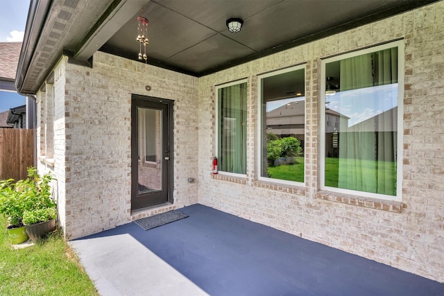 view of exterior entry featuring a patio area