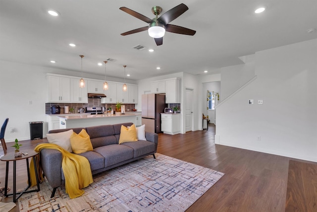 living room with ceiling fan and light hardwood / wood-style flooring