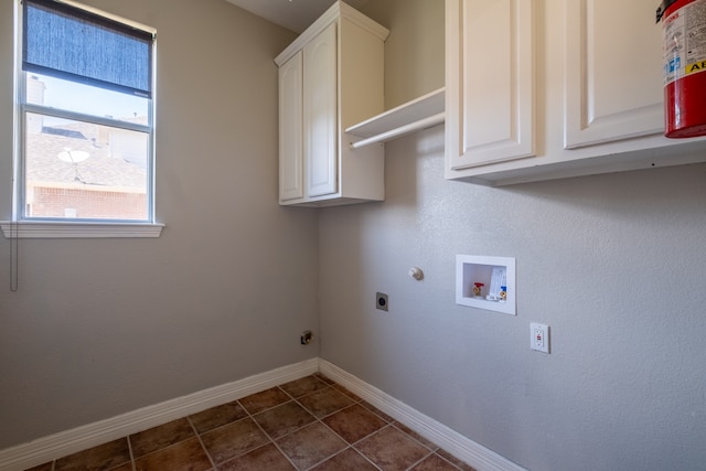 laundry room with cabinets, tile patterned floors, electric dryer hookup, and washer hookup