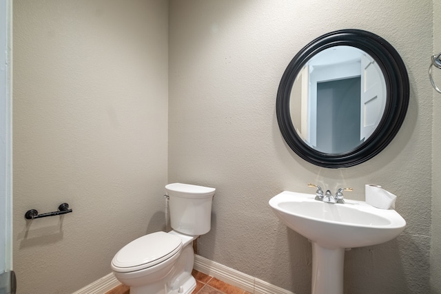 bathroom with toilet and tile patterned flooring