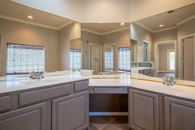 bathroom featuring a shower with door, tile patterned flooring, dual bowl vanity, and crown molding