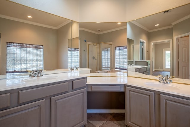 bathroom featuring crown molding, tile patterned floors, a shower with door, and vanity