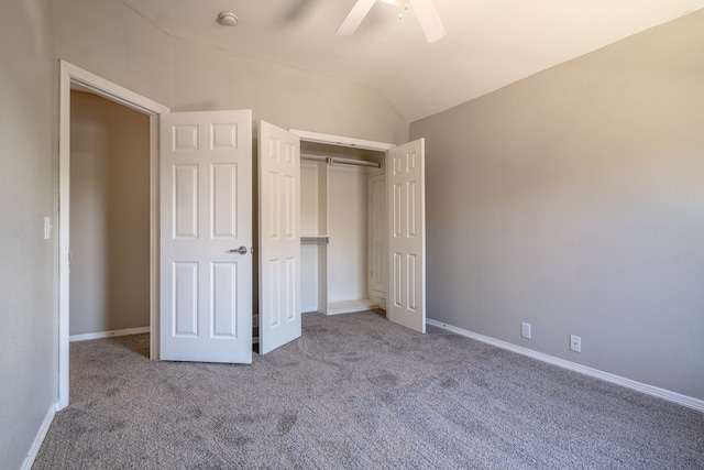 unfurnished bedroom with carpet, ceiling fan, lofted ceiling, and a closet