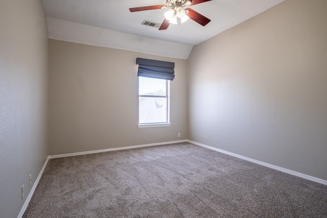 carpeted spare room with lofted ceiling and ceiling fan