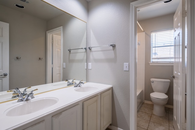 full bathroom with double vanity, tile patterned flooring, toilet, and shower / bathtub combination