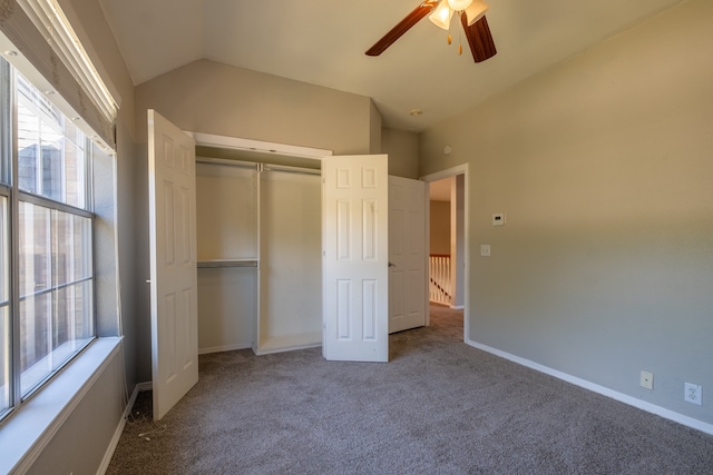 unfurnished bedroom with ceiling fan, lofted ceiling, carpet flooring, and a closet