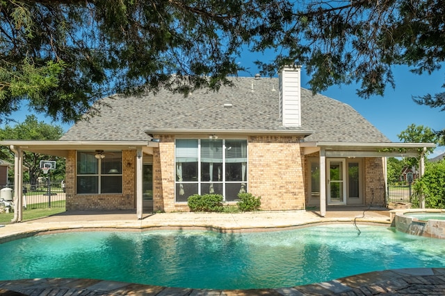 view of swimming pool with an in ground hot tub, a patio, and ceiling fan