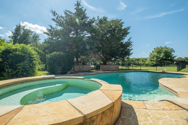 view of swimming pool featuring an in ground hot tub