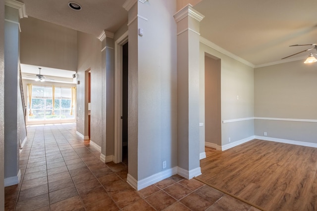 hall with ornate columns, ornamental molding, and dark wood-type flooring