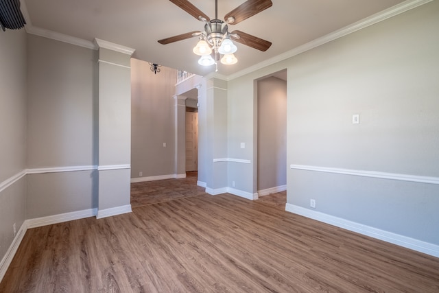 empty room with ceiling fan, hardwood / wood-style floors, and crown molding