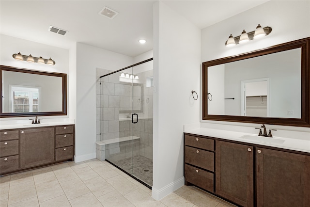 bathroom with walk in shower, vanity, and tile patterned floors