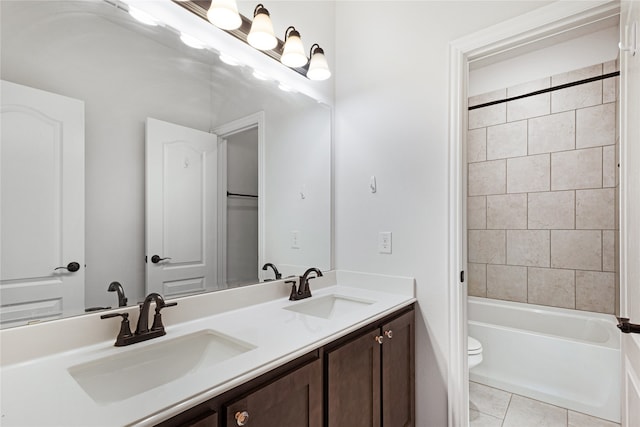 full bathroom with vanity, tile patterned flooring, toilet, and tiled shower / bath