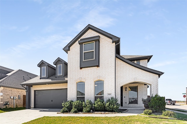 view of front of home with a garage and a front yard