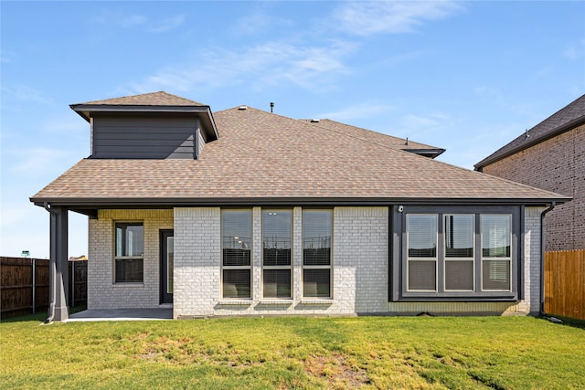 back of property with a patio and a lawn