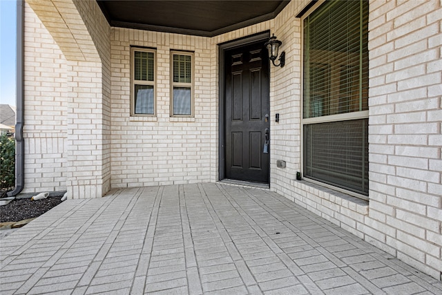 view of exterior entry featuring a porch