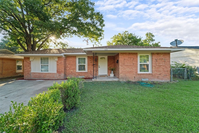 ranch-style home featuring driveway, a front yard, fence, and brick siding