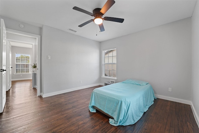 bedroom featuring dark wood-style floors, baseboards, visible vents, and ceiling fan