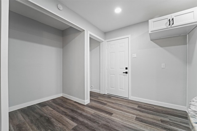 interior space with recessed lighting, dark wood-style flooring, and baseboards