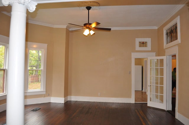 spare room featuring ceiling fan, dark hardwood / wood-style flooring, ornate columns, and ornamental molding