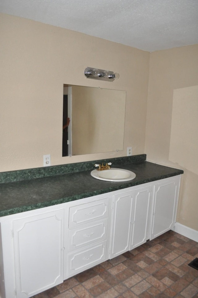 bathroom with vanity and a textured ceiling