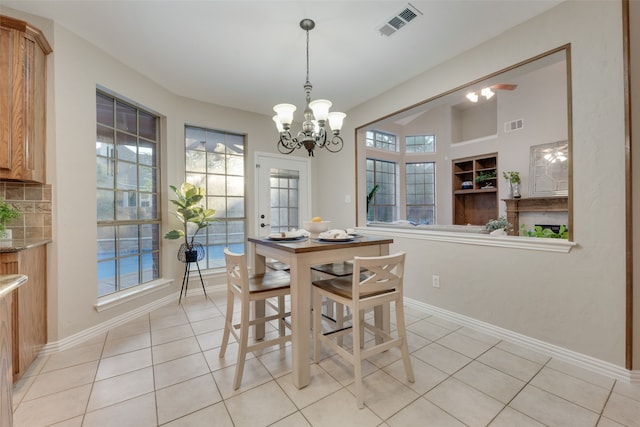 dining space with light tile patterned floors and a chandelier