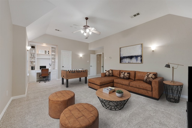 carpeted living room with built in features, lofted ceiling, and ceiling fan