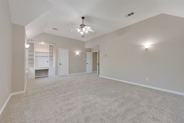 unfurnished bedroom featuring a closet, ceiling fan, vaulted ceiling, and light colored carpet