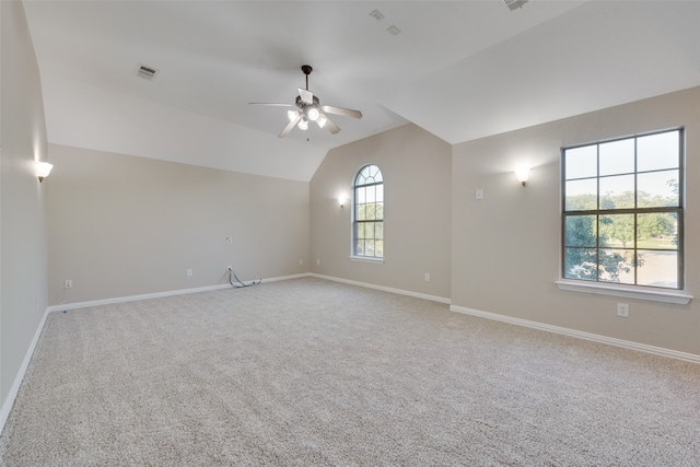 unfurnished room featuring lofted ceiling, carpet floors, and ceiling fan