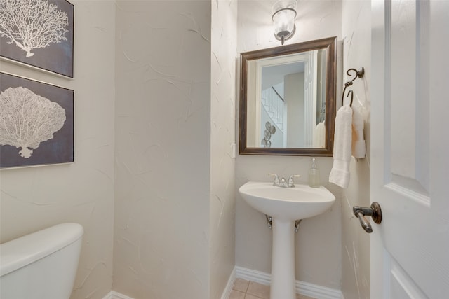 bathroom featuring toilet and tile patterned flooring