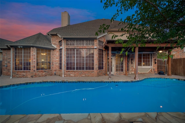 view of pool at dusk