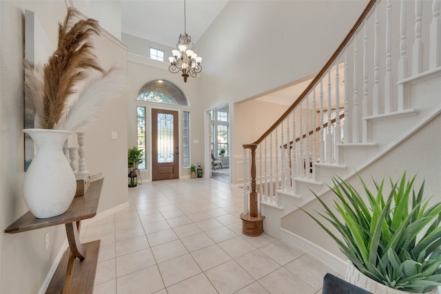 tiled foyer with a notable chandelier and a high ceiling