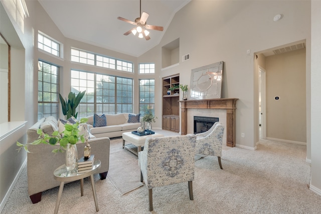 carpeted living room featuring high vaulted ceiling, a fireplace, and ceiling fan