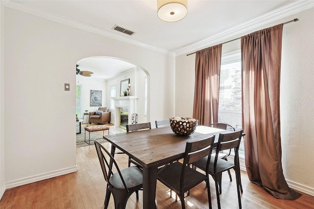 dining room featuring ceiling fan, crown molding, and light wood-type flooring