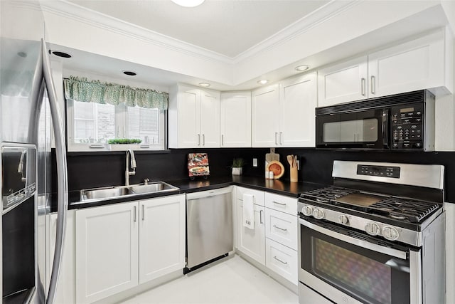 kitchen featuring appliances with stainless steel finishes, backsplash, crown molding, sink, and white cabinets