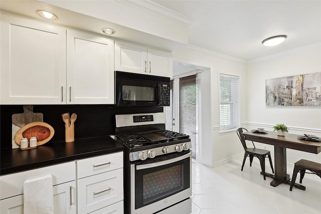 kitchen with white cabinetry, light tile patterned floors, ornamental molding, and stainless steel range with gas stovetop