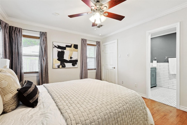 bedroom featuring ensuite bath, ceiling fan, wood-type flooring, and ornamental molding