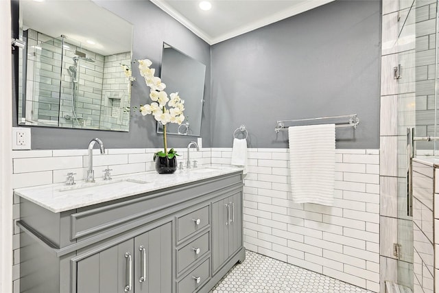 bathroom with tile patterned floors, an enclosed shower, vanity, tile walls, and ornamental molding