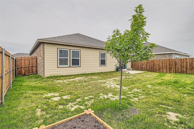 rear view of property featuring a lawn