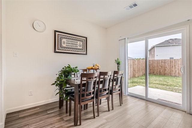 dining area with light hardwood / wood-style floors