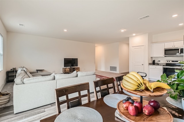 living room with light hardwood / wood-style floors