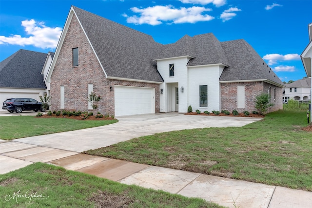 view of front of property featuring a garage and a front yard