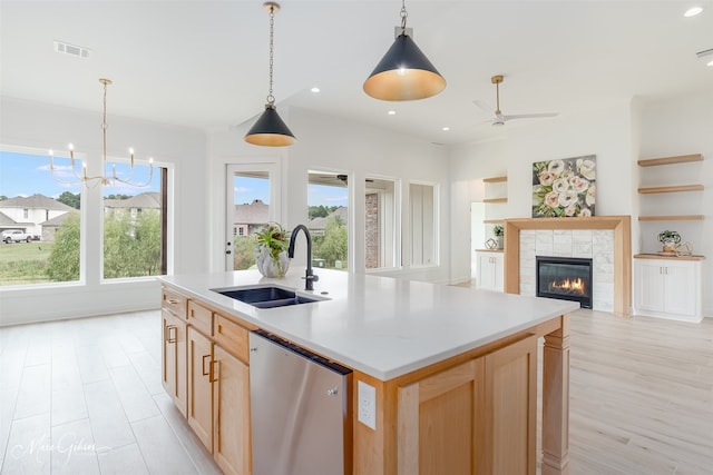 kitchen with dishwasher, an island with sink, sink, and plenty of natural light