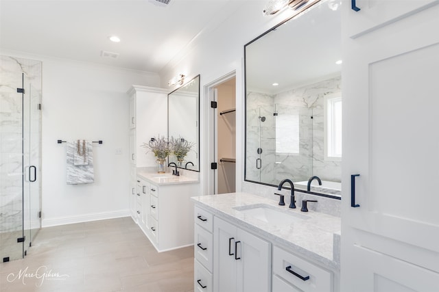 bathroom featuring double vanity, walk in shower, and ornamental molding