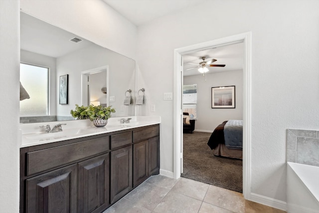 bathroom featuring tile patterned floors, vanity, ceiling fan, and a wealth of natural light