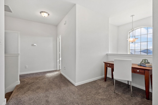 home office with dark carpet and a notable chandelier