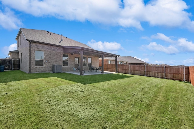 rear view of house with a yard and a patio area