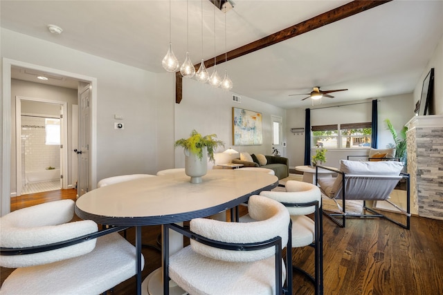 dining space with ceiling fan and dark hardwood / wood-style flooring