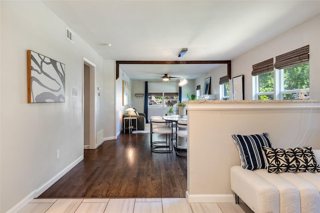 interior space with ceiling fan and wood-type flooring