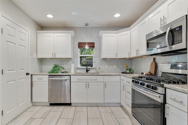 kitchen with white cabinets, appliances with stainless steel finishes, and sink